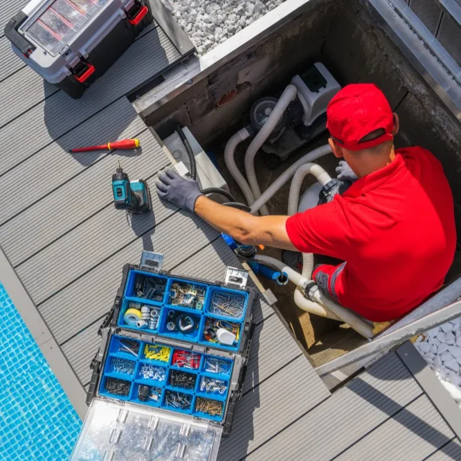 A man in a red shirt and red hat doing a leak detection and repair services