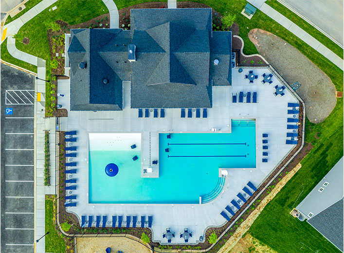 An aerial view of residential house with a large swimming pool